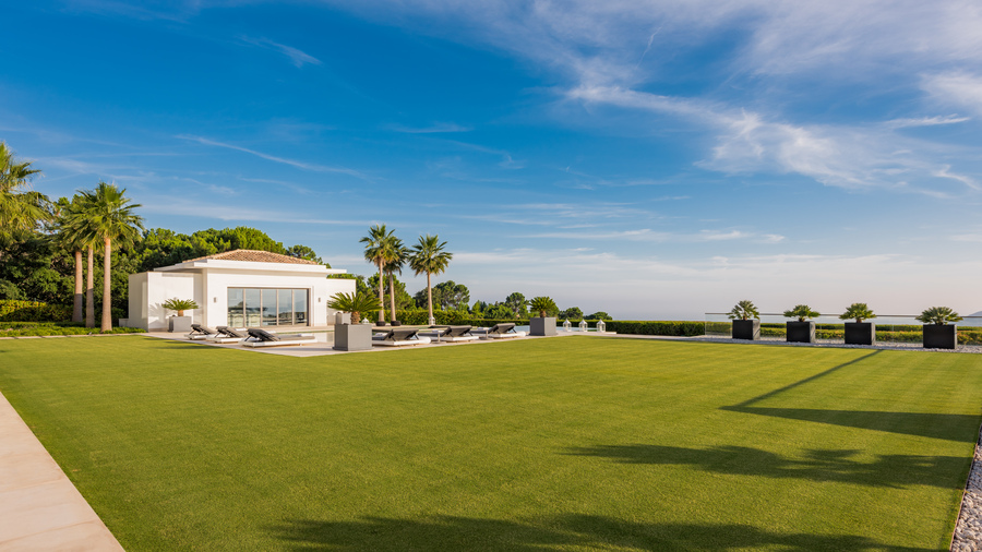 Spacious green lawn and sustainable garden integrated into the natural environment of La Zagaleta.
