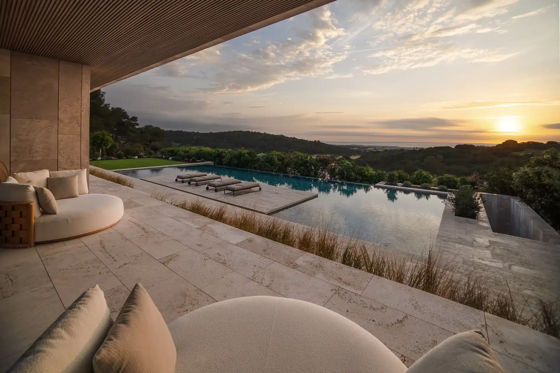 Sunset views from a seamless infinity terrace overlooking the Mediterranean coastline and landscape.