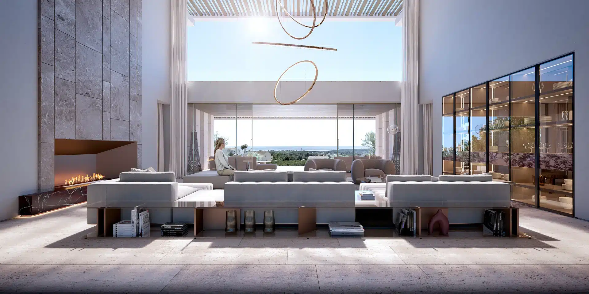 Modern interior design in Sotogrande featuring a minimalist sofa, built-in shelving, and floor-to-ceiling windows overlooking the coast.