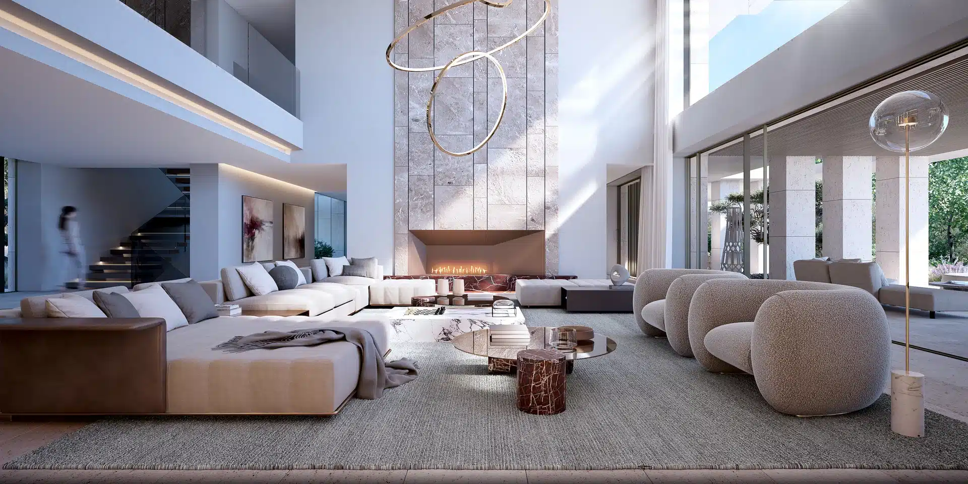 Sophisticated open-plan living room featuring a marble fireplace, sculptural lighting, and double-height ceilings in Sotogrande.