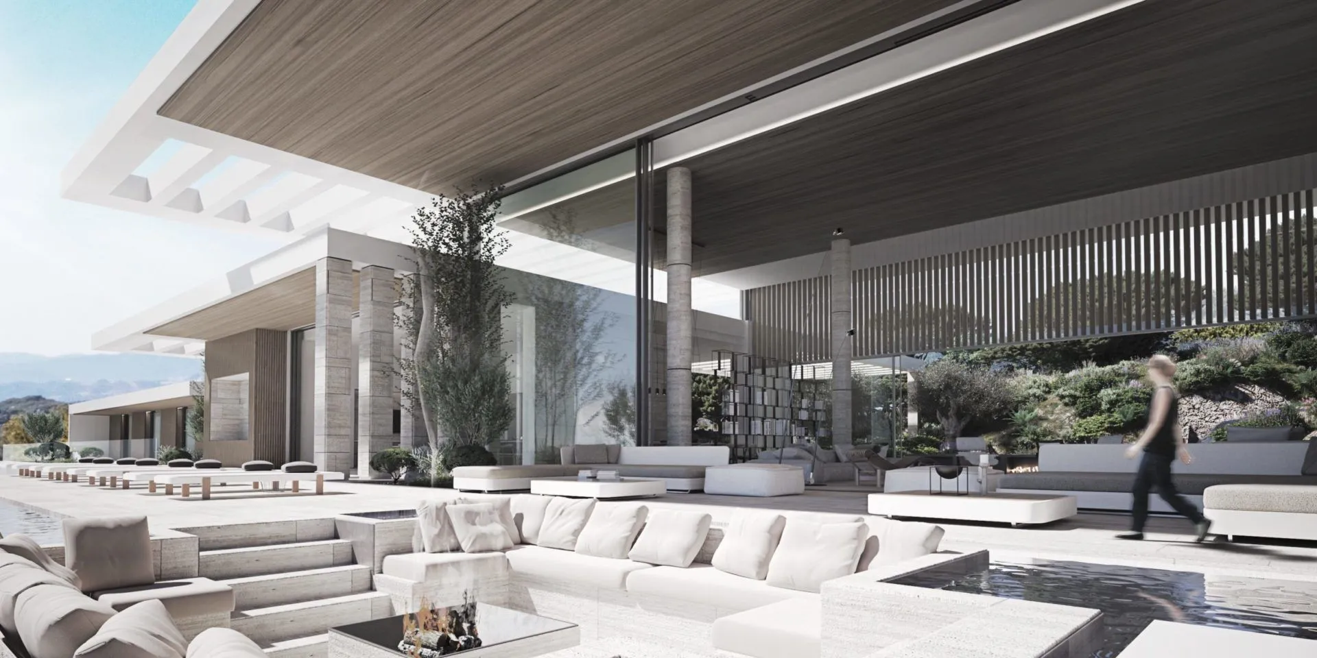 Sophisticated outdoor fire pit lounge with minimalist white sofas and contemporary architectural lighting.