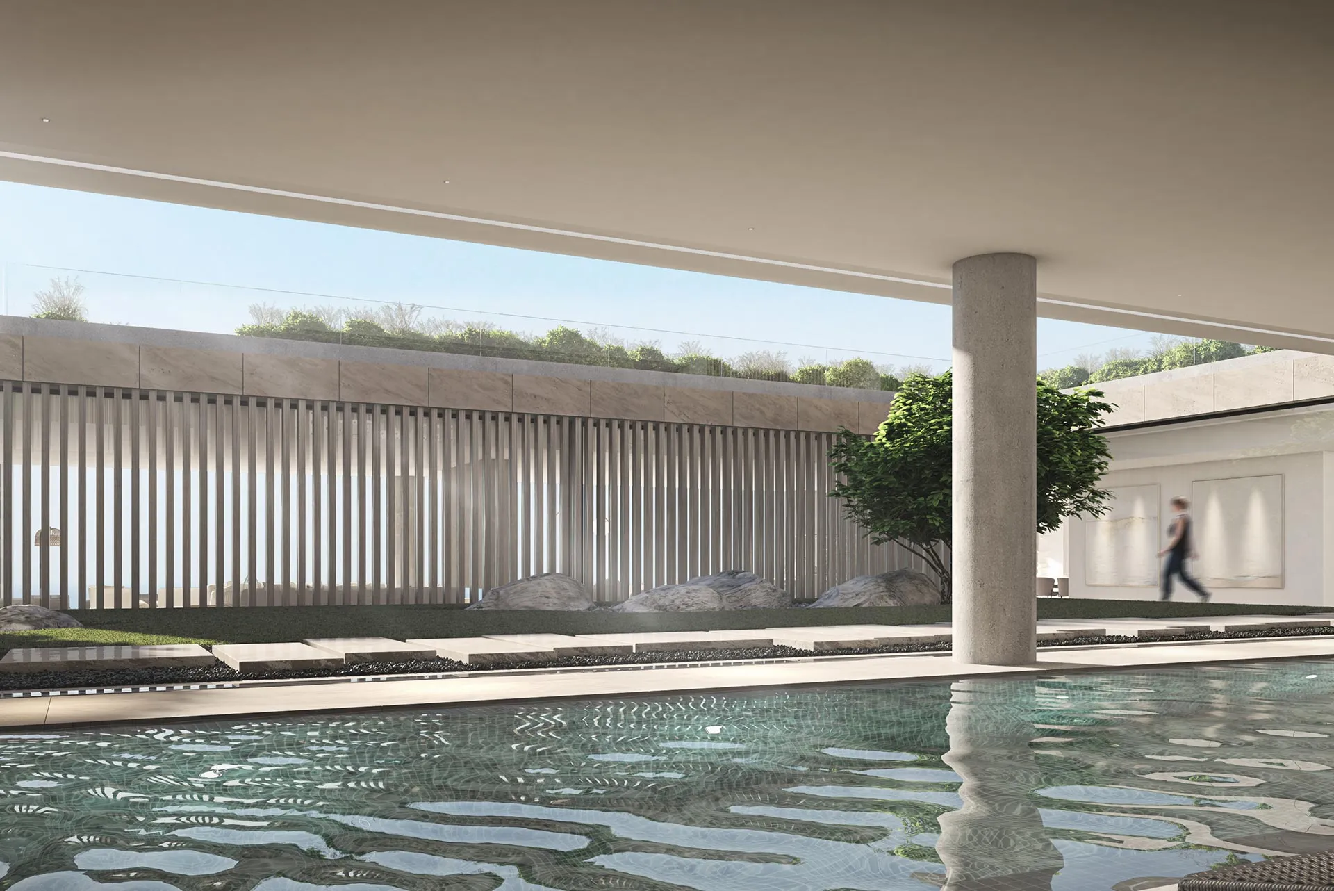 Modern infinity pool area with seamless indoor-outdoor transition and limestone flooring.