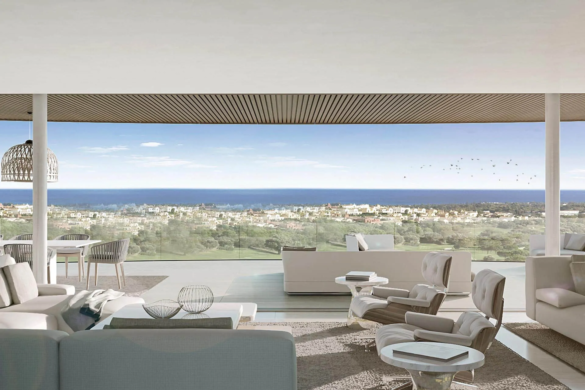 Contemporary open-plan living area featuring a minimalist terrace and panoramic Mediterranean coastline views.