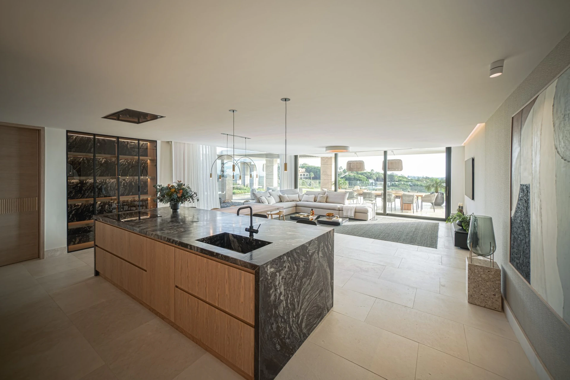 gourmet kitchen with central stone island in Villa White, Sotogrande, combining functionality with high-end ARK Architects design