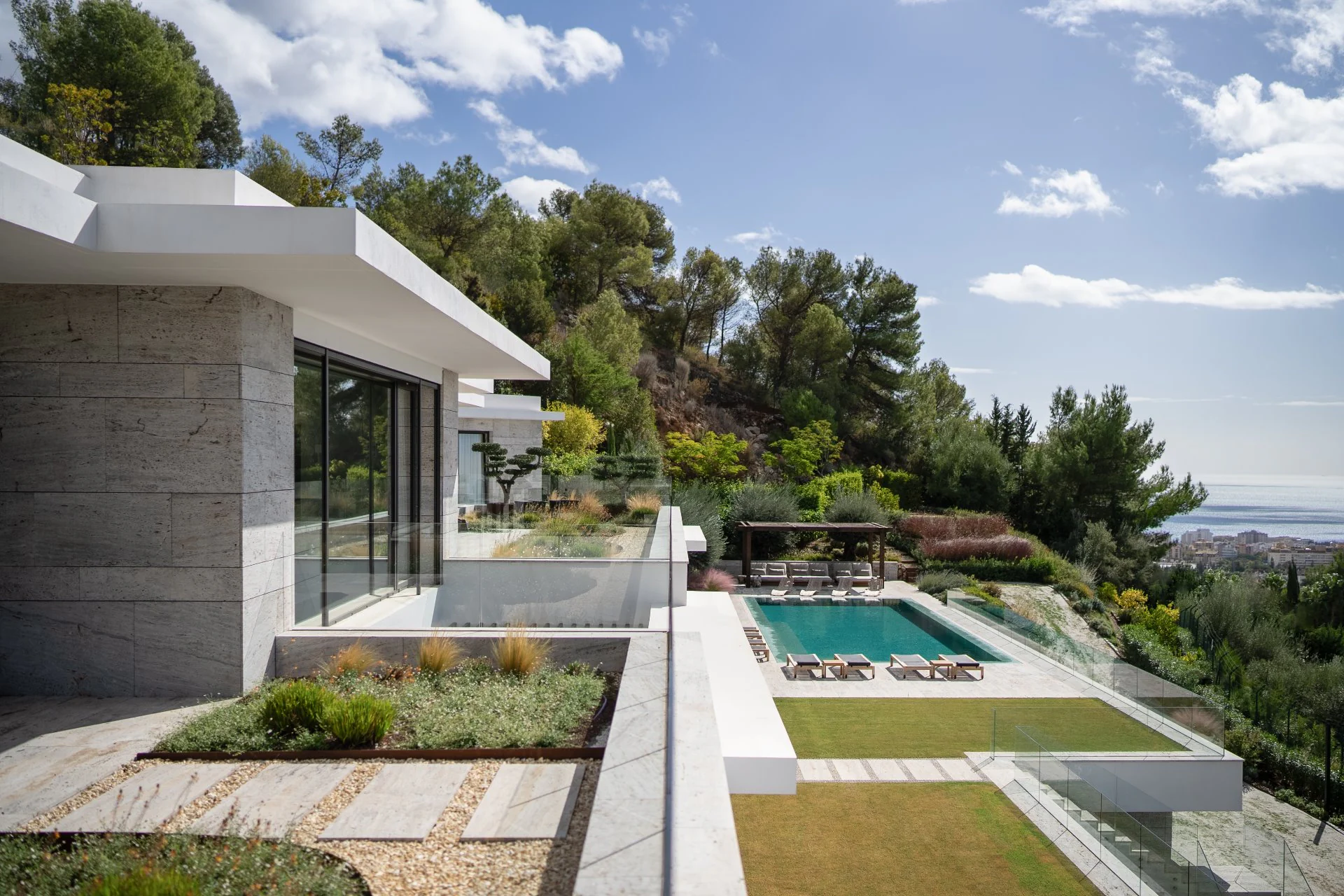 White architectural lines and cantilevered terraces overlooking the garden in Marbella.