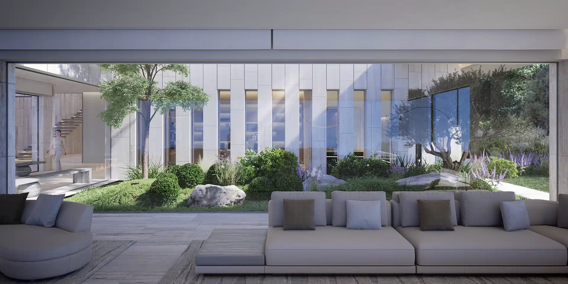 Sophisticated living area opening onto a Mediterranean-style internal patio with lush greenery.