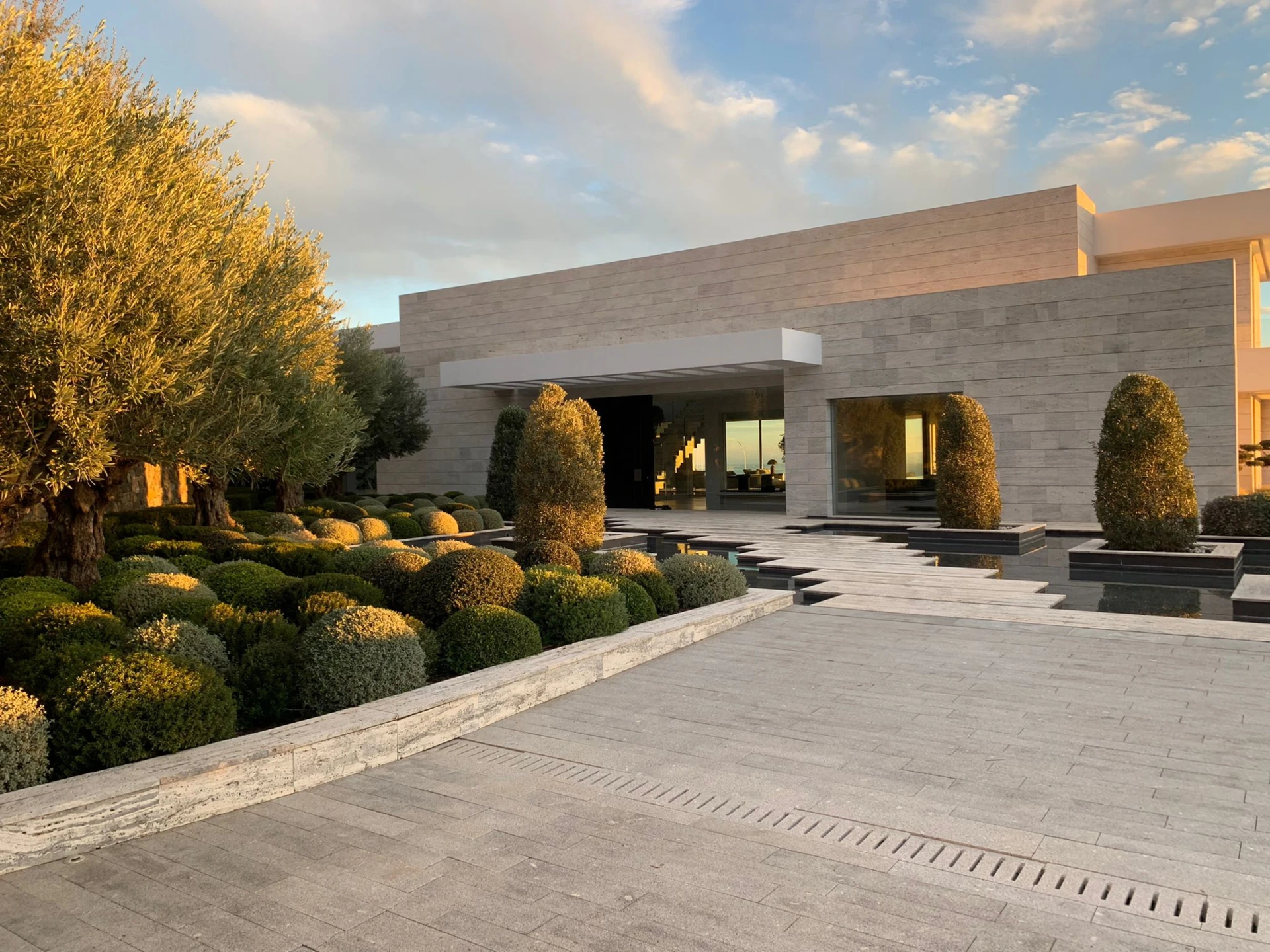 Lateral view of a contemporary bespoke villa highlighting cantilevered structures and natural light.