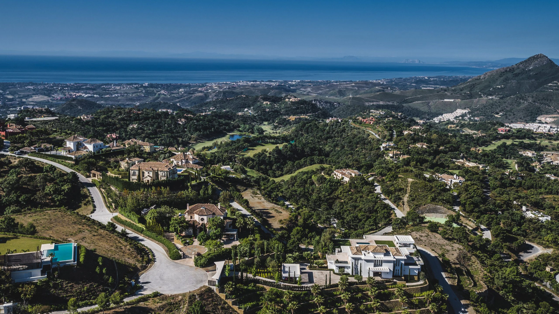 Panoramic landscape of La Zagaleta showcasing luxury villas winding roads and sea horizon ark real estate experts