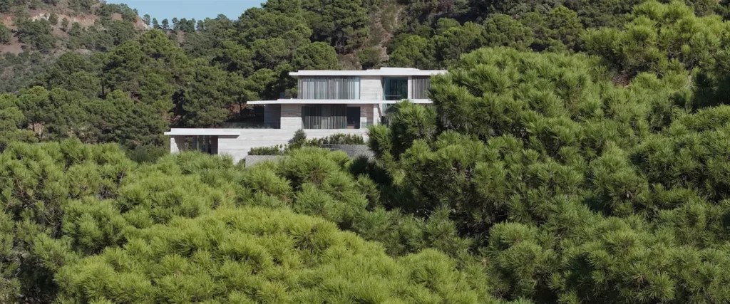 Architectural shot of Villa Geneve highlighting its perfect balance with the surrounding Mediterranean forest.